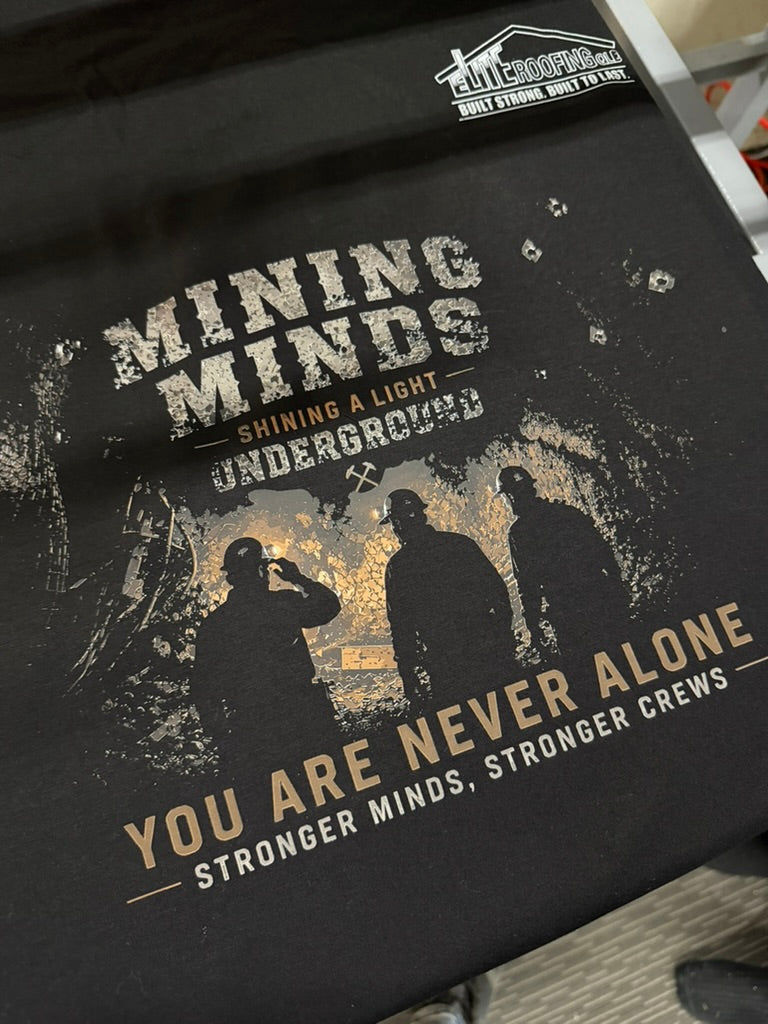 Mining Minds message and miner silhouettes printed on black fabric.
